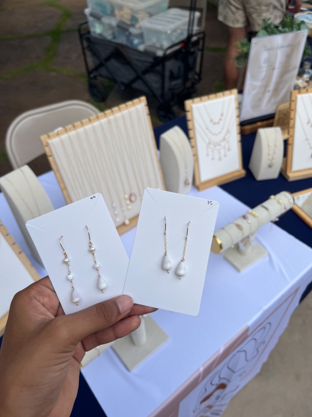 Pearl drop earrings in hand